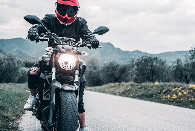 a man riding a motorcycle down a curvy road