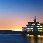 lighted cruiseship on sea taken during golden hour
