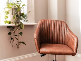 brown and black rolling chair beside green plant