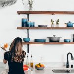 woman standing in front of kitchen sink