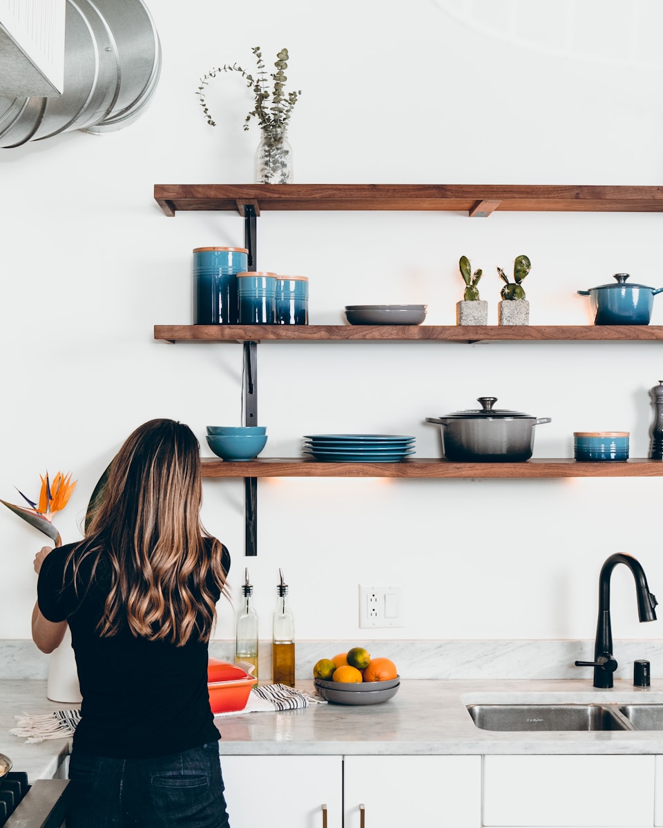 woman standing in front of kitchen sink