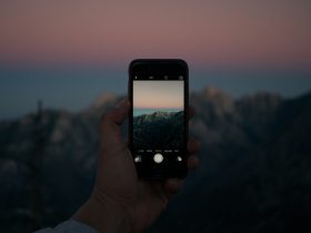 selective focus photography of person taking photo using iPhone