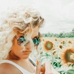 woman standing on sunflower field