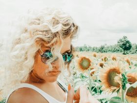 woman standing on sunflower field