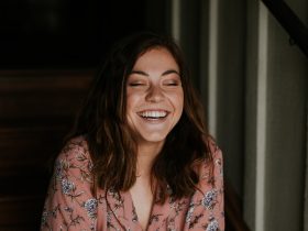 woman sitting on wooden stair smiling