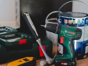 red and black cordless power drill beside black and red cordless power drill